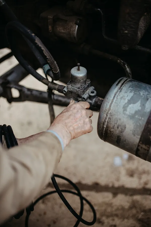 Technician working by hand on engine components at the bench