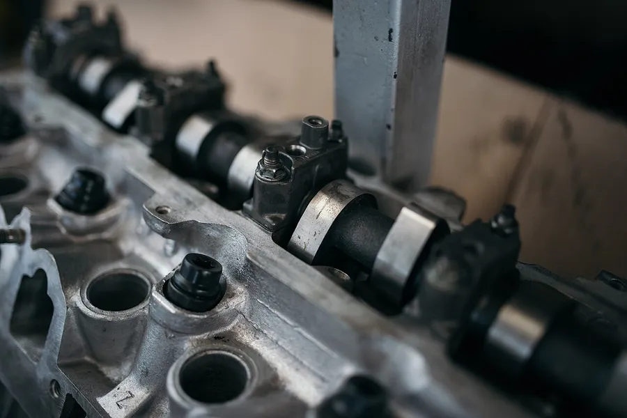 Cylinder head with camshaft being measured on the bench