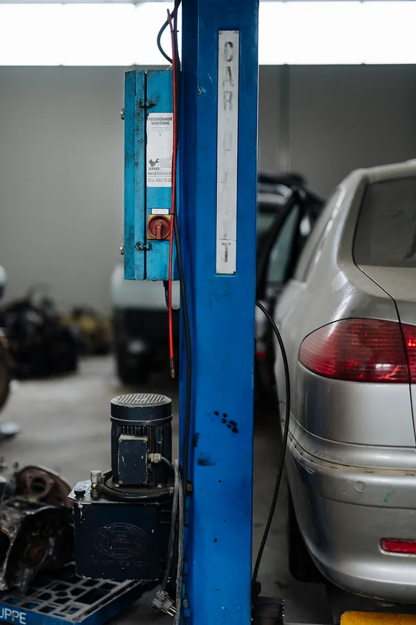 Vehicle raised on a two-post lift in the service bay